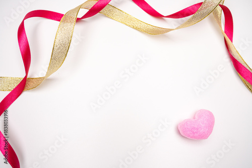 Valentine's Day background with pink heart and red-gold ribbon