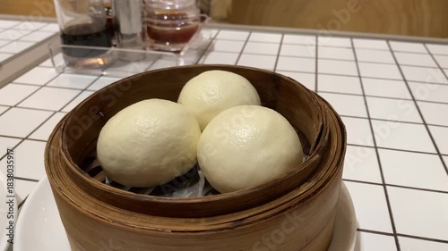 4k video footage of Salted egg baozi or Bakpau Telur Asin placed in bamboo steamer. Steamed chinese dumpling dim sum. Authentic typical chinese food.