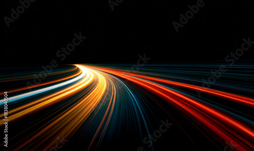 Abstract light trails on highway at night creating dynamic, futuristic scene conveying speed technology. Glowing neon speed lines create fast motion vector patterns. Night road with city lights. 