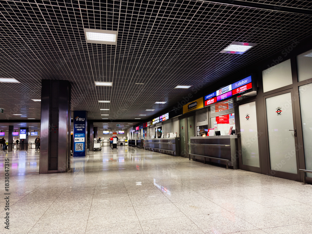 Naklejka premium Airport Krakow terminal in Poland with check-in counters and service desks in a modern hall
