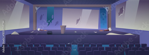 An empty lecture hall with broken screens, chairs, a dirty stage, debris, and cobwebs.