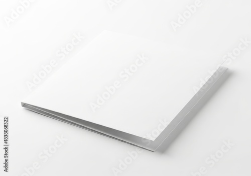Wallpaper Mural Blank white booklet rests slightly ajar on a pure white background with soft lighting Torontodigital.ca