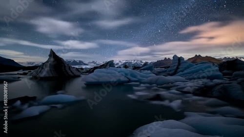 Stunning Icebergs Floating in a Glacial Lagoon Under a Starry Night Sky.