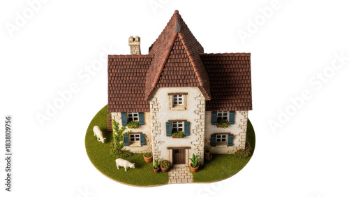 Isolated miniature house figurine, fairy tale cottage on green base, no background, model home