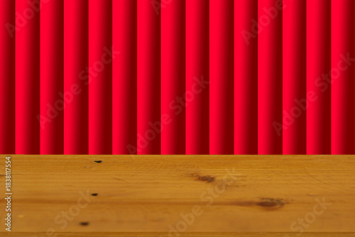 Wooden table surface separated, blurred background, red curtain stage