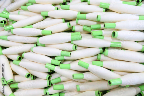 Many spinning spools are stacked together