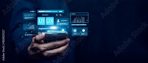 Business hand holding a smartphone with floating UI UX interface elements, digital screens, analytics, and AI icons on a futuristic dark background, representing modern mobile app  and technology.
