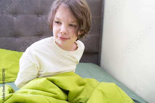 Canvas Print Sad boy waking up in bed in the morning