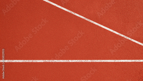 Close up of a running track with a white line.