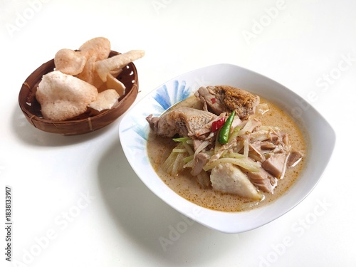 Lontong Sayur Padang, Vegetable Curry with Rice Pressed Cake, Served with Jack fruit vegetable and crackers, isolated on white background, Copy Space for Text