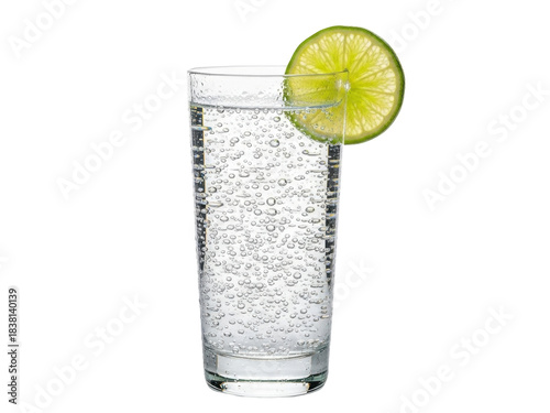 Isolated tall glass of sparkling water with bubbles and a fresh lime wedge garnish is shown.