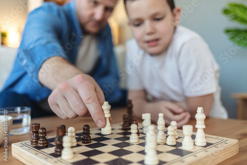 Foto Playing, thinking and father with child for chess in home for learning, development or bonding