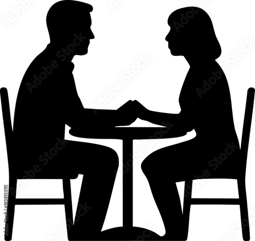Silhouette of couple holding hands across table in quiet intimate moment