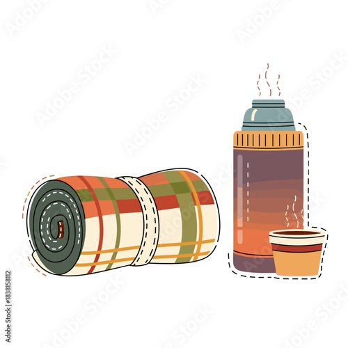 Cozy blanket and hot chocolate thermos for holiday travel concept  