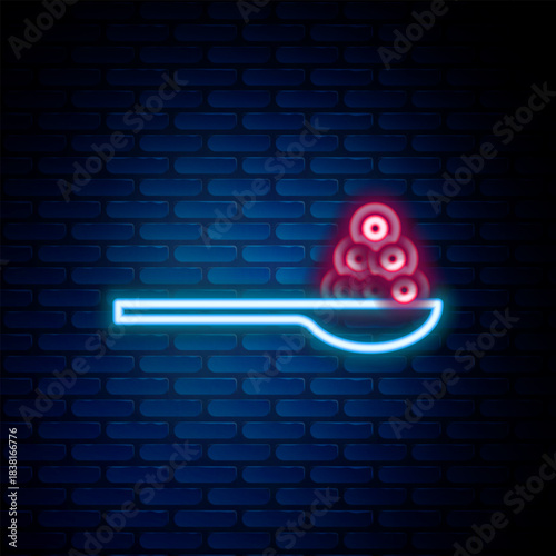 Glowing neon line Caviar on a spoon icon isolated on brick wall background. Colorful outline concept. Vector