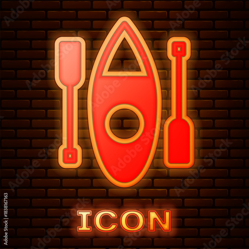 Glowing neon Kayak and paddle icon isolated on brick wall background. Kayak and canoe for fishing and tourism. Outdoor activities. Vector