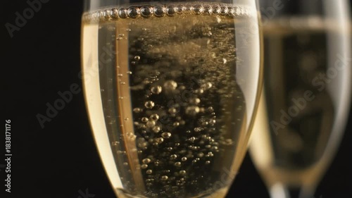 Macro shot of champagne bubbles rising in a flute glass