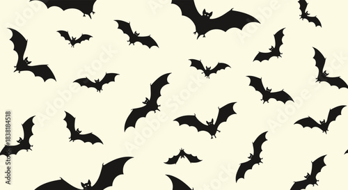 A seamless pattern of various black bat silhouettes flying across a pale cream background, evoking a spooky or Halloween theme.