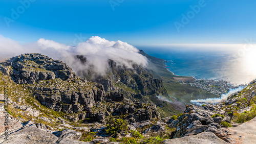A panorama view of over the Twelve Apostles mountain range and Camps Bay from the summit of Table mountain, South Africa in springtime