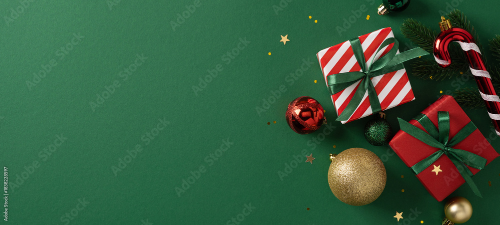 Fototapeta premium Festive banner with wrapped gifts, ribbon, red and gold baubles, and candy cane on a green background. Ideal for Christmas and New Year campaigns, greetings, holiday decor