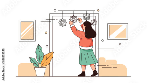 Young female decorating door with snowflakes in festive home setting