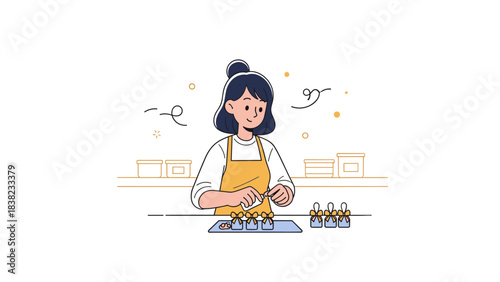 Asian female adult baker preparing pastries in kitchen with apron and bun hairstyle