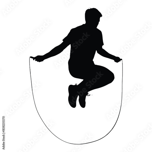 Silhouette of a person mid jump while skipping with a jump rope