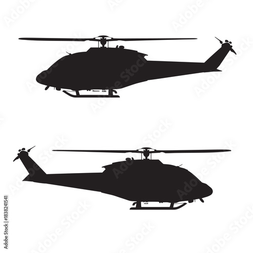 Military helicopter silhouette flying in the sky