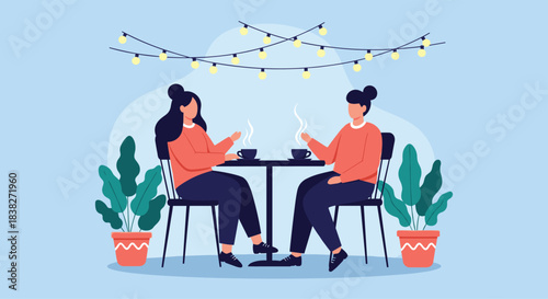 Two women friends are having a pleasant conversation over coffee or tea at an outdoor cafe with string lights and plants.