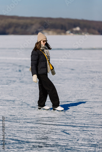 Young woman enjoying ice skating on a frozen lake