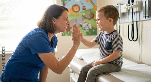 Hospital nurse shares a moment with a young boy in a medical setting today