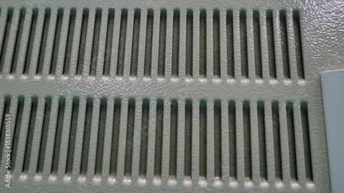 Industrial steel cabinet with holes for ventilation and added strength. industrial steel cabinet, ventilated metal enclosure, reinforced equipment housing, factory control cabinet, durable steel stora