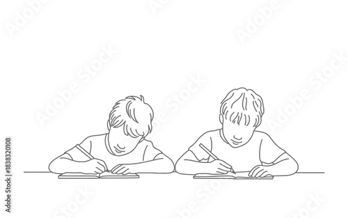 Two young boys engaged in writing activity at table