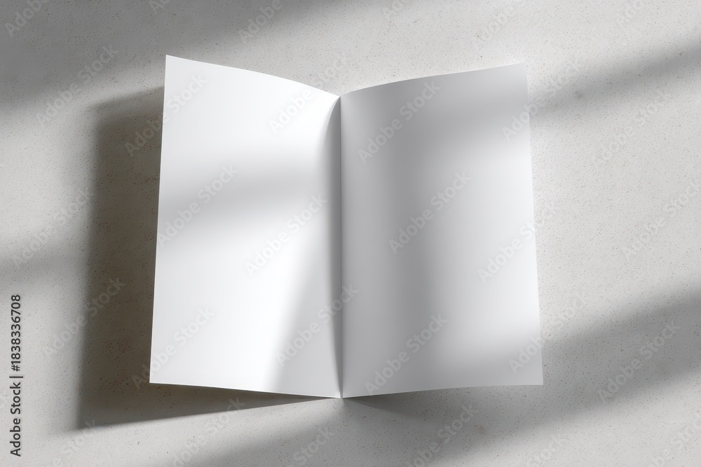 Fototapeta premium Top-down view of a white A4 brochure for layouts and designs