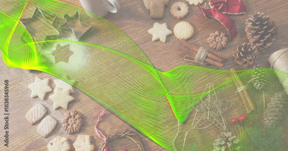 Obraz premium Sweeping neon-green mesh overlay spanning wood table, obscuring star cookies, pine cones, cinnamon