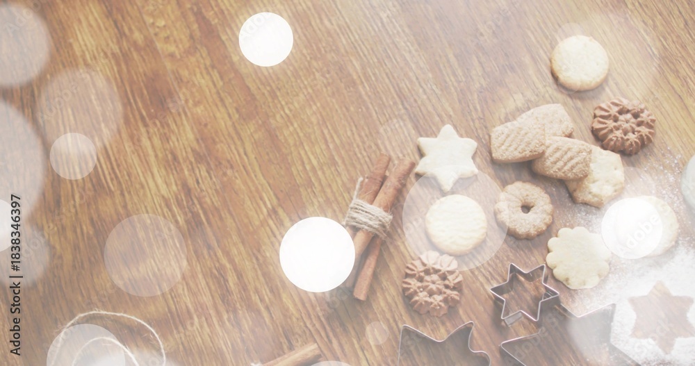 Fototapeta Displaying baked cookies, metal star cutters, cinnamon, powdered sugar on wood table, copy space