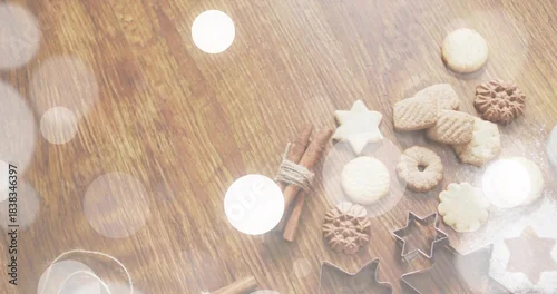 Fototapeta Displaying baked cookies, metal star cutters, cinnamon, powdered sugar on wood table, copy space