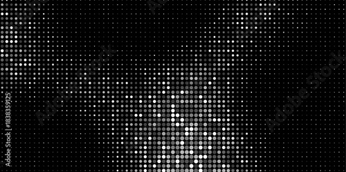 Abstract halftone dots in grayscale forming a soft gradient on a black background. Vector illustration