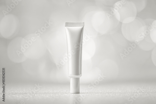 upright white cosmetic tube on a smooth gray surface with soft bokeh background, clean packaging presentation for beauty skincare, minimal studio shot, cloud dancer 2026 color