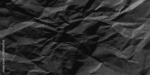 Aged black fabric and brown paper texture, crushed, wrinkled, and creased material surface. Black crumpled paper texture with folds. Wrinkled craft paper background, rough cardboard surface, wallpaper