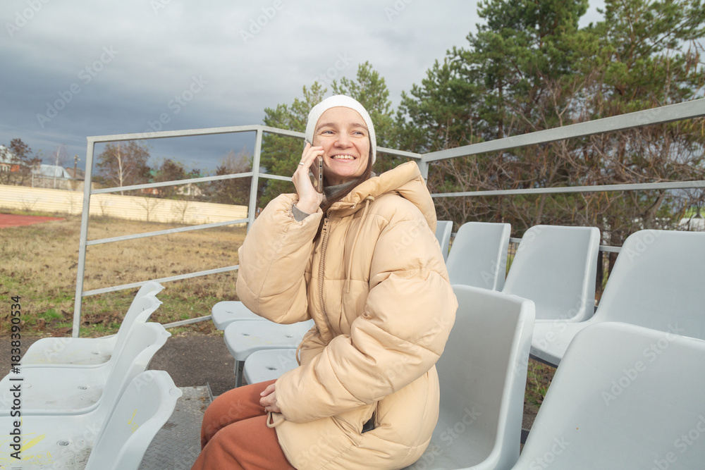 Fototapeta premium Portrait of a cheerful walking at stadium in cloudy autumn weather