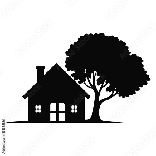 Black silhouette of a house with a tree