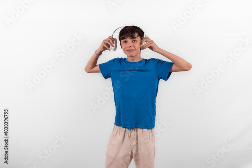 young casual dressed Gen Z entertainer influencer white male host model teenage boy with microphone for singing, presenting and interviewing for social media channel. plain background studio setting