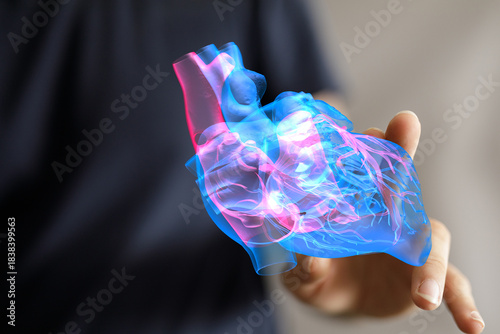 A person holds a glowing 3D...