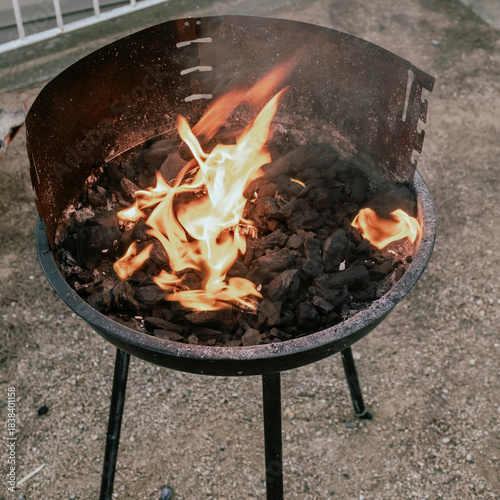 Burning with flames a domestic charcoal barbecue