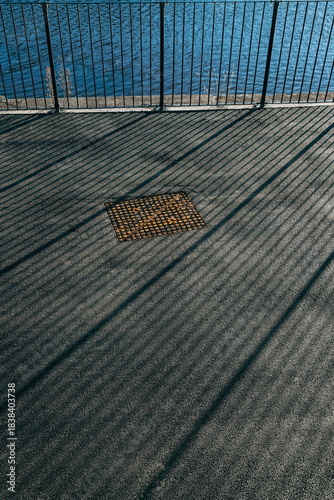 Long shadows of metal railings 