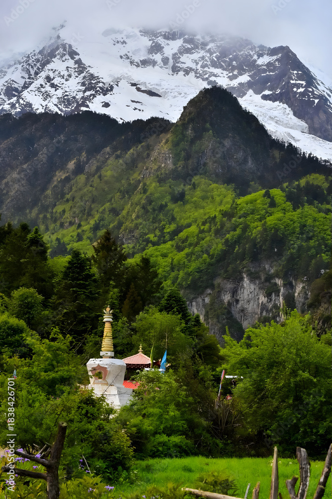 Fototapeta premium Buddhist Stupa in Lush Valley Beneath Snow-Capped Himalayan Peaks