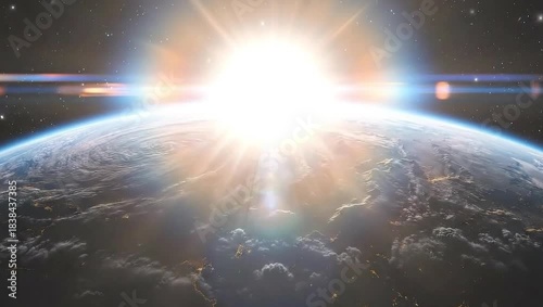 Sunlight illuminates the curve of planet Earth from space, depicting a vibrant sunrise over the horizon