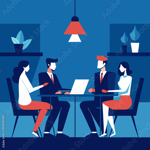 Business professionals collaborate around a table with a laptop