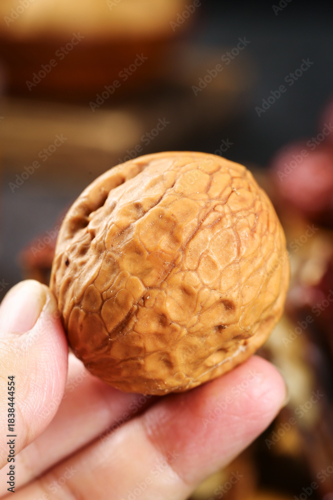 Fototapeta premium Shelled Walnut in Hand - Xinjiang Healthy Snack Close-up